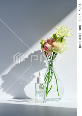 Serum with a dropper with spring flowers. Serum with a dropper with spring flowers. 102326923