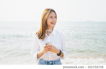 hand holding smartphone with using social media on internet. Summer lifestyle concept. hand holding smartphone with using social media on internet. Summer lifestyle concept. 102330156