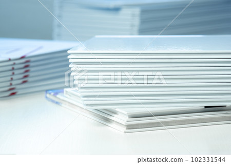 stack of photo books close-up, partial blur stack of photo books close-up, partial blur 102331544