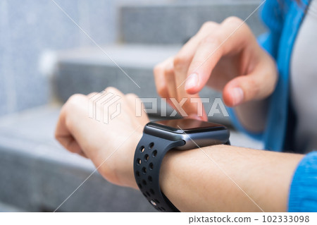 Woman wearing a smartwatch and touching to check on o'clock. Woman wearing a smartwatch and touching to check on o'clock. 102333098