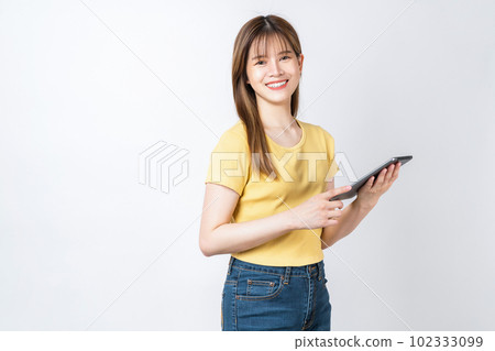 Studio shot of Beautiful Asian businesswoman holding digital tablet and smiling on white background. Studio shot of Beautiful Asian businesswoman holding digital tablet and smiling on white background. 102333099