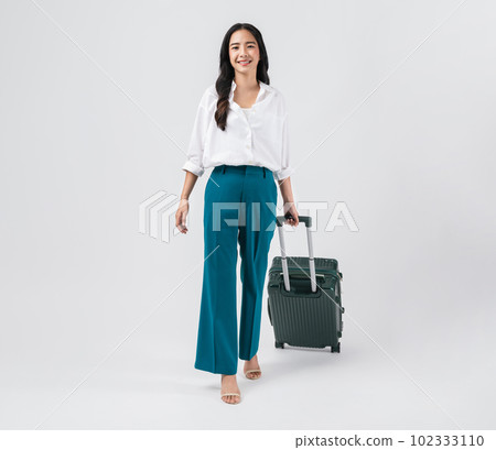 Cheerful young Asian woman holding suitcase with walking to the front, isolated on white background. Cheerful young Asian woman holding suitcase with walking to the front, isolated on white background. 102333110