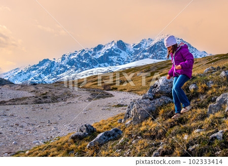 little girl hiking in scenic mountains of Abruzzo - Gran Sasso National Park in Italy - hike kids little girl hiking in scenic mountains of Abruzzo - Gran Sasso National Park in Italy - hike kids 102333414