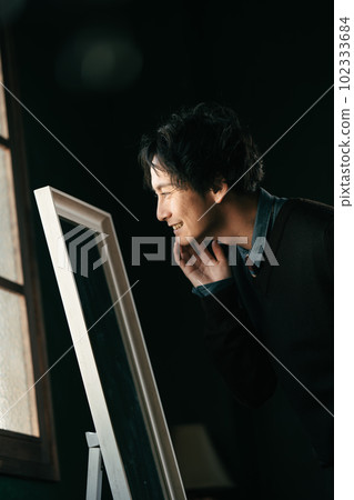 A man checking the condition of his skin A man checking the condition of his skin 102333684