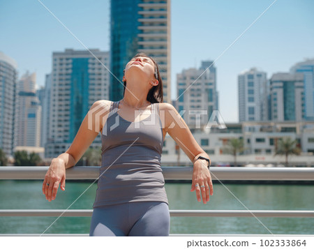 City Running - asian woman runner and Dubai marina skyline. City Running - asian woman runner and Dubai marina skyline. 102333864