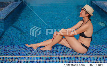 asian woman relaxing in swimming pool spa 102333893