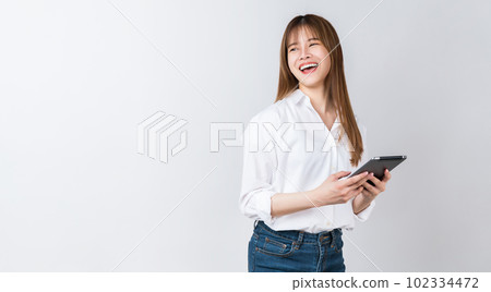 Studio shot of Beautiful Asian businesswoman holding digital tablet and smiling on white background. Studio shot of Beautiful Asian businesswoman holding digital tablet and smiling on white background. 102334472