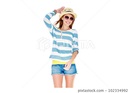 In the summertime...Studio shot of a young woman dressed for summer isolated on white. In the summertime...Studio shot of a young woman dressed for summer isolated on white. 102334992