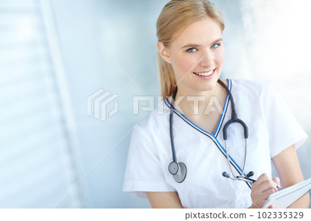 Figuring out how to cure you. Portrait of a smiling nurse writing notes in her notepad with copyspace. Figuring out how to cure you. Portrait of a smiling nurse writing notes in her notepad with copyspace. 102335329