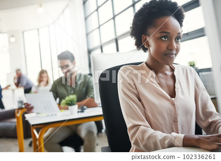 Get things done with the right resources. a designer working on her computer at her desk. 102336261