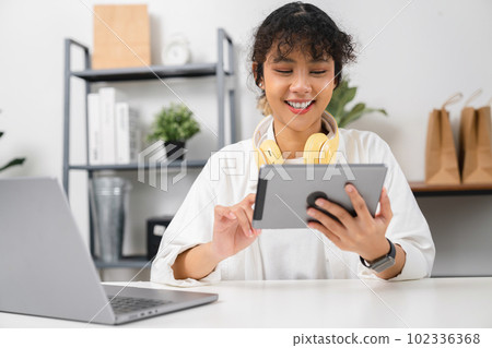Asian woman using digital tablet with video calling meeting and study online on the Internet. Asian woman using digital tablet with video calling meeting and study online on the Internet. 102336368