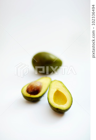 Avocado half, fruit and healthy food in studio with color, art and creativity for nutritionist. Salad, wellness diet and nutrition with clean, green or vegan ingredient isolated on a white background Avocado half, fruit and healthy food in studio with color, art and creativity for nutritionist. Salad, wellness diet and nutrition with clean, green or vegan ingredient isolated on a white background 102336494