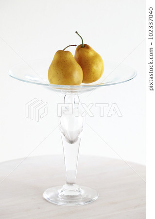 Compote and pear in a glass photographed on a white background 102337040