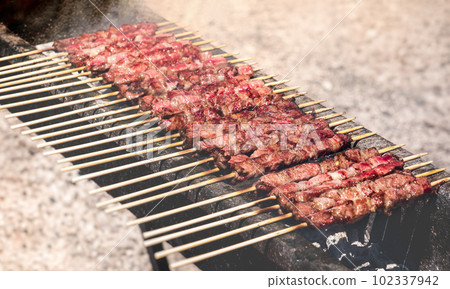 Arrosticini Abruzzesi grill in Campo Imperatore - Abruzzo - south italy cooking  102337942