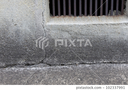 Cracked ventilation base of an old detached house Cracked ventilation base of an old detached house 102337991