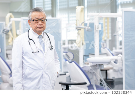 Male doctor in a white coat Male doctor in a white coat 102338344