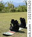 Snowboard and lawn Shiba training and sunny sky 102338420