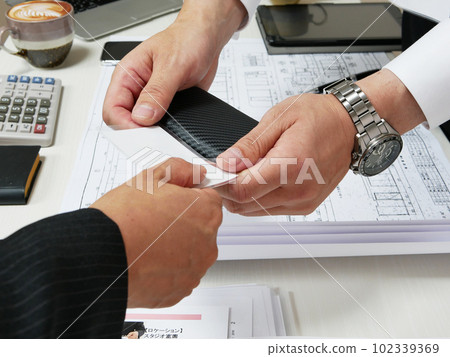 Businessman exchanging business cards during a meeting Businessman exchanging business cards during a meeting 102339369