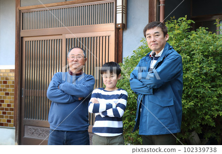 A family (three men) are comparing their greatness with their arms folded A family (three men) are comparing their greatness with their arms folded 102339738
