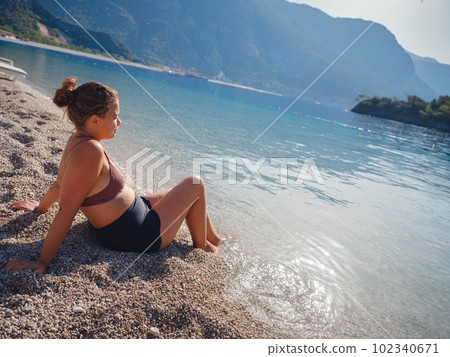 Cheerful woman enjoying the beach 102340671