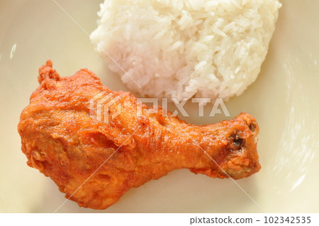 crispy fried salty chicken drumstick eat with sticky rice on plate 102342535