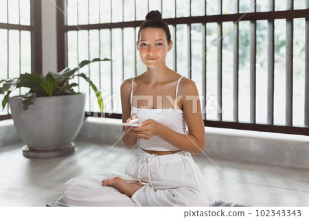 Yoga and Connection, Fit Woman Using Mobile Phone During Indoor Practice 102343343