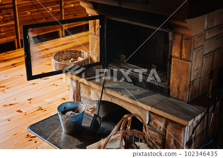 How to Remove Wood Ashes In Fireplace, How To Properly Clean Ashes Out Of Home Fireplace. Cleaning fireplace with open tray. Fireplace, wicker basket for firewood, pile of logs for a fire How to Remove Wood Ashes In Fireplace, How To Properly Clean Ashes Out Of Home Fireplace. Cleaning fireplace with open tray. Fireplace, wicker basket for firewood, pile of logs for a fire 102346435
