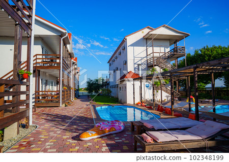 Hammocks, loungers are poolside amenities for guests to relax, soak up the sun 102348199
