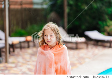 Cute teenage girl with wet hair and in a towel after swimming in the pool. Cute teenage girl with wet hair and in a towel after swimming in the pool. 102348214