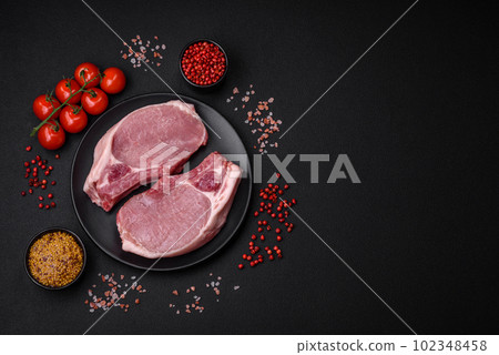 Raw pork on the bone or rib sliced with salt, spices and herbs 102348458
