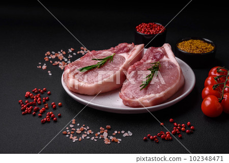 Raw pork on the bone or rib sliced with salt, spices and herbs 102348471