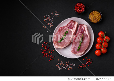 Raw pork on the bone or rib sliced with salt, spices and herbs Raw pork on the bone or rib sliced with salt, spices and herbs 102348472