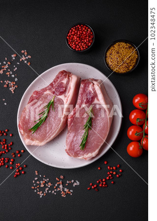 Raw pork on the bone or rib sliced with salt, spices and herbs Raw pork on the bone or rib sliced with salt, spices and herbs 102348475