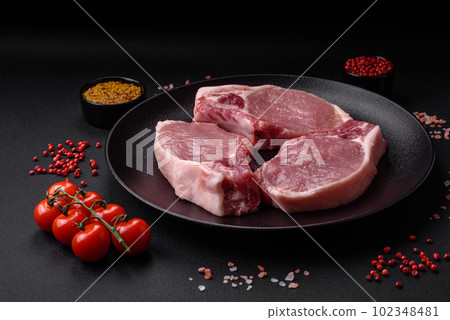 Raw pork on the bone or rib sliced with salt, spices and herbs 102348481