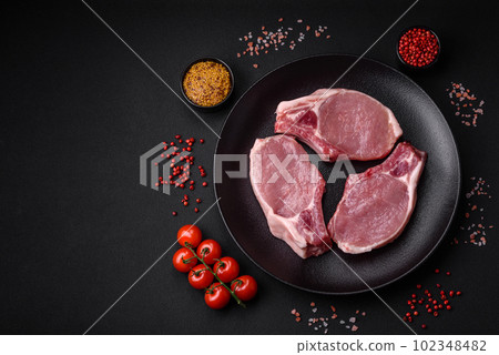 Raw pork on the bone or rib sliced with salt, spices and herbs 102348482