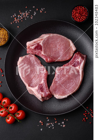 Raw pork on the bone or rib sliced with salt, spices and herbs Raw pork on the bone or rib sliced with salt, spices and herbs 102348483
