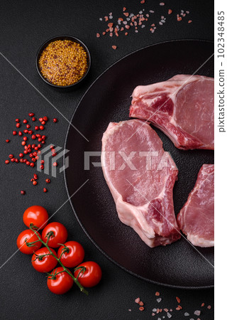 Raw pork on the bone or rib sliced with salt, spices and herbs 102348485