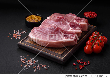 Raw pork on the bone or rib sliced with salt, spices and herbs 102348497