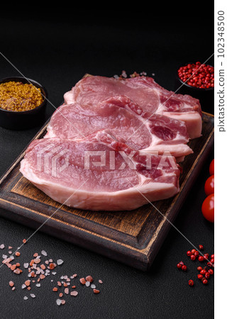 Raw pork on the bone or rib sliced with salt, spices and herbs Raw pork on the bone or rib sliced with salt, spices and herbs 102348500