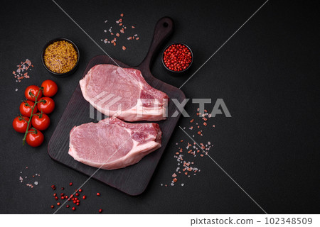 Raw pork on the bone or rib sliced with salt, spices and herbs 102348509