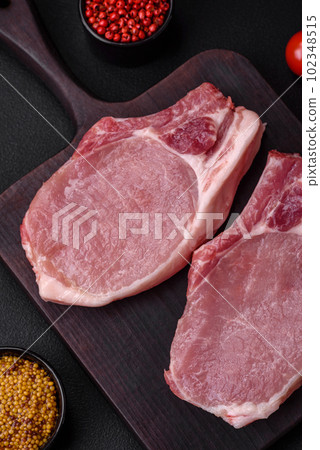 Raw pork on the bone or rib sliced with salt, spices and herbs 102348515