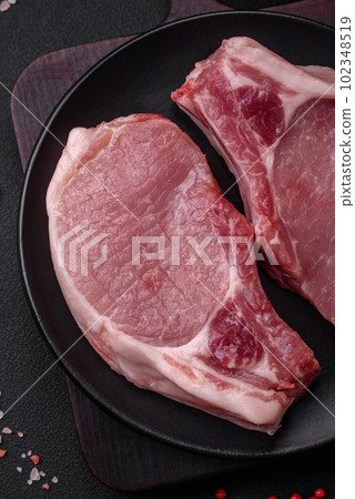 Raw pork on the bone or rib sliced with salt, spices and herbs 102348519