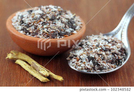 Medicinal herbs on a wooden surface Medicinal herbs on a wooden surface 102348582