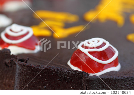 Decorated cherry on a party cake Decorated cherry on a party cake 102348624