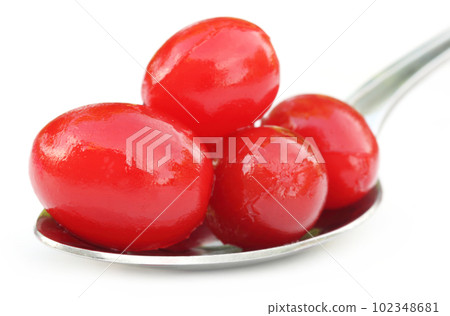 Processed cherry on a silver spoon Processed cherry on a silver spoon 102348681