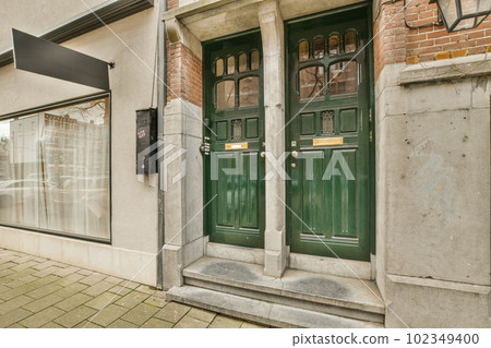 a green door on the side of a building that has been painted with white paint and is in front of it a green door on the side of a building that has been painted with white paint and is in front of it 102349400