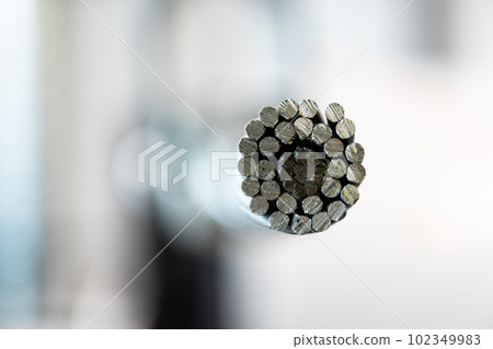 High voltage electric cable cross section on blurred bokeh background 102349983