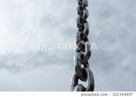 Steel chain with clouds on sky on background 102349997