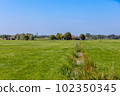 Green meadows and farms in the village of Sassenheim in the Netherlands. 102350345