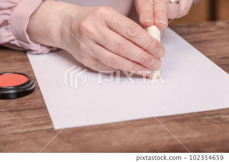 [Woman stamping the seal with vermilion] 102354659